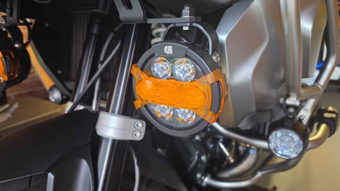 DENALI D7 Pro auxiliary light with amber X-Lens mounted to a BMW GS crash bar